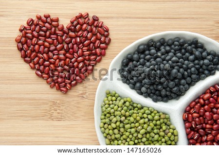 Love beans. red bean, green bean and black bean in a plate on wood. view on top, with text space