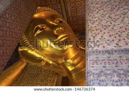 BANGKOK ,THAILAND - JULY 4 : Reclining Buddha gold statue face. Wat Pho on July 4, 2013 in Bangkok, Thailand