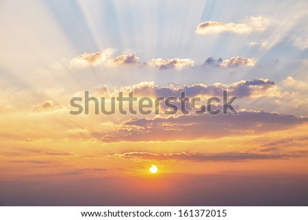 Blue sky with clouds and sun reflection