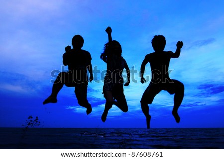 jumping team at sunset time as silhouette background