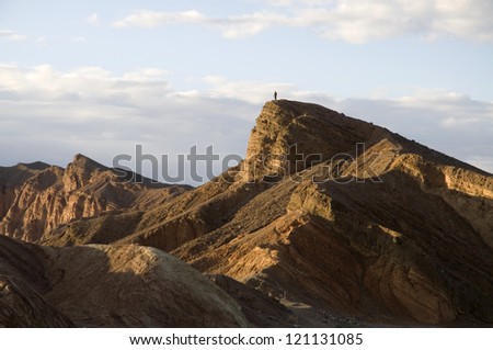A tiny figure on a mountaintop in Death Valley National Park.