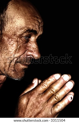 Old man praying,wrinkled and sun burned skin