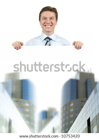 Business man holding a white board with corporate buildings , top of the world