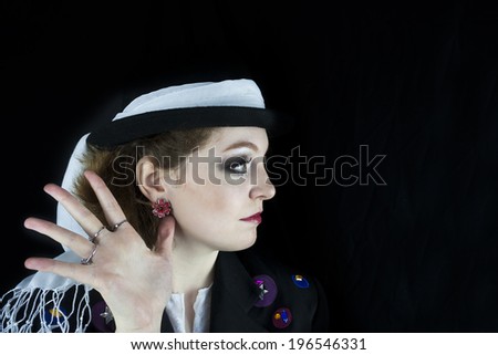 Profile of beautiful young woman wearing hat and white scarf