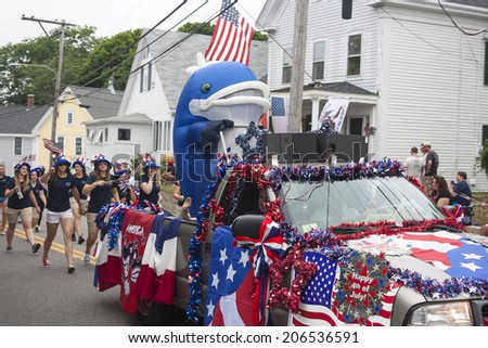 Wellfleet, Massachusetts, USA-July 4, 2014: Person in a whale costume riding in the back of a truck in the Wellfleet 4th of July Parade in Wellfleet, Massachusetts.