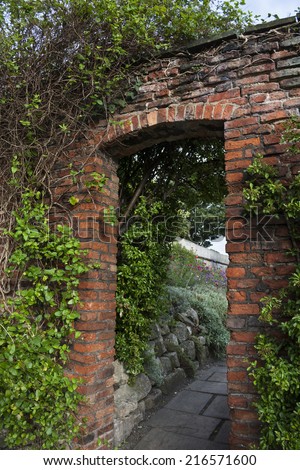 Brick, garden doorway in English garden in England