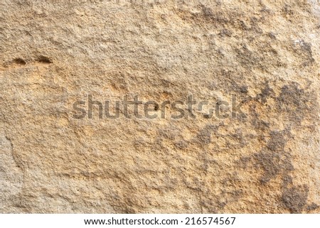 Rough rock background texture with orange and gray tints