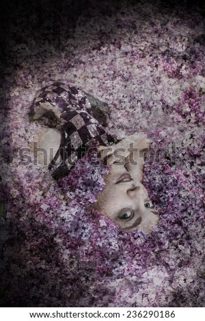 Woman wearing black and silver sequin dress lying in lilac flowers