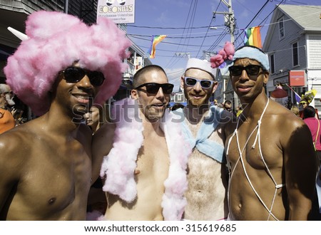 Provincetown, Massachusetts, USA-August 20, 2015: People walking in the 37th Annual Provincetown Carnival Parade in Provincetown, Massachusetts.