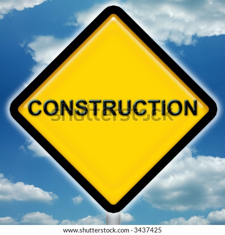 Bright yellow construction sign with blue sky background
