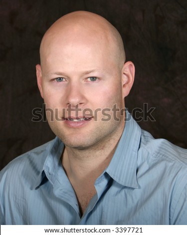 bald man posing for photo