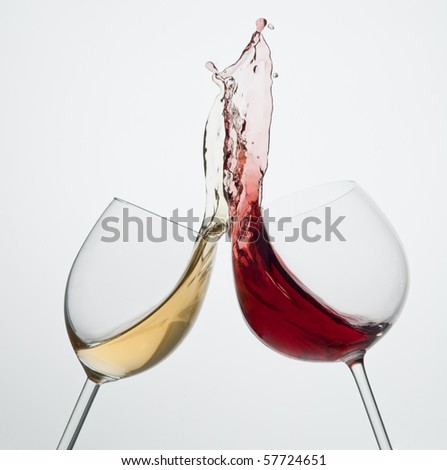 Toasting gesture red and white wine with big splash big splash