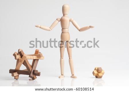 Wooden man figure thinking about what to choose. Bigger or smaller problem?