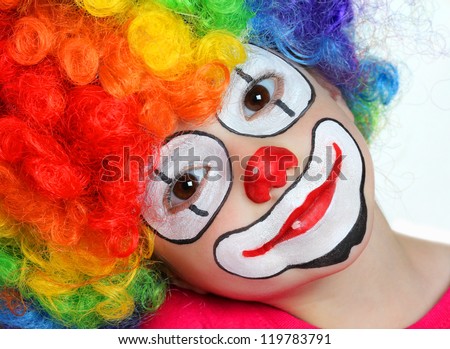 Pretty girl with face painting of a clown
