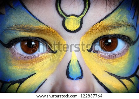 Close-up picture of eyes from a young girl with face painting.
