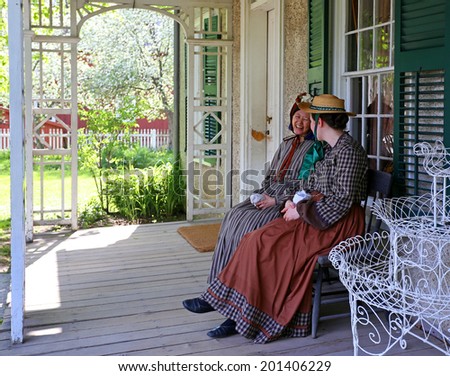 TORONTO  MAY 26: Two females rest on the bench in Black Pioneer Village, a living history museum in Toronto, Ontario, Canada in May 26, 2014.