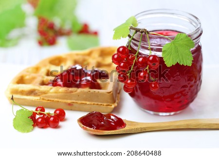 Waffles with red currant jam and fresh berries.