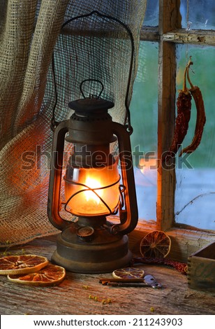 Old fashioned kerosene lantern style oil lamp.