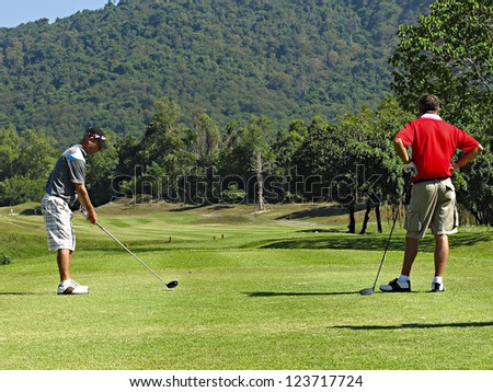 PATTAYA, THAILAND - DECEMBER 28: Unidentified middle aged men playing golf on a scenic golf course near Pattaya, Chonburi on December 28, 2010. Pattaya has 25 golf courses close to the city.