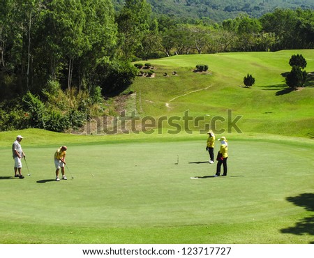 PATTAYA, THAILAND - DECEMBER 28: Unidentified middle aged men playing golf on a scenic golf course near Pattaya, Chonburi on December 28, 2010. Pattaya has 25 golf courses close to the city..