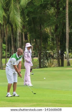 PATTAYA, THAILAND - MAY 29: Unidentified man chipping on 7th hole at Green Valley St Andrews golf course on May 29, 2013. Pattaya has 25 golf courses close to the city.