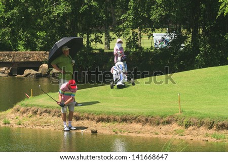 PATTAYA, THAILAND - MAY 29: Unidentified man chipping on 4th hole at Green Valley St Andrews golf course on May 29, 2013. Pattaya has 25 golf courses close to the city.