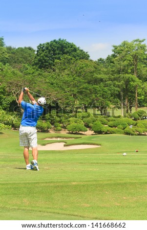 PATTAYA, THAILAND - MAY 29: Unidentified man on backswing on fairway at 8th hole on Green Valley St Andrews golf course on May 29, 2013. Pattaya has 25 golf courses close to the city.