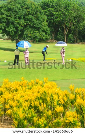 PATTAYA, THAILAND - MAY 29: Unidentified asian man tee off on 16th hole on Green Valley St Andrews golf course on May 29, 2013. Pattaya has 25 golf courses close to the city.