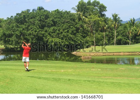 PATTAYA, THAILAND - MAY 29: Unidentified man on backswing on fairway to 4th hole at Green Valley St Andrews golf course on May 29, 2013. Pattaya has 25 golf courses close to the city.