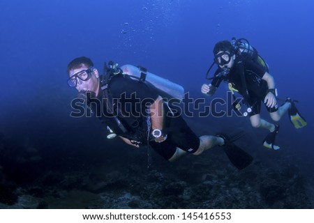 KHAO LAK, THAILAND - NOVEMBER 24: Scuba diver leading a group underwater on a dive site in Similan Islands on November 24, 2009 . Similan Islands are Thailand\'s premier dive destination.