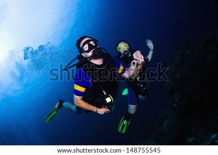 KHAO LAK, THAILAND - NOVEMBER 24: Two scuba divers holding hands on a dive in Similan Islands on November 24, 2009 . Similan Islands are Thailand\'s premier dive destination.