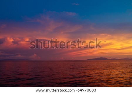 Dramatic colorful sunset on endless ocean horizon in Komodo National Park, Indonesia