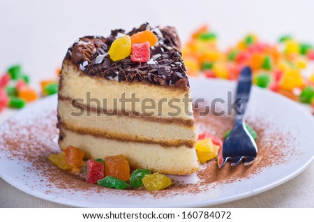 Sponge cake with chocolate topping and colorful dried pineapple