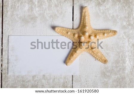 Card with Few marine items on a wooden background . Sea Objects over wooden planks