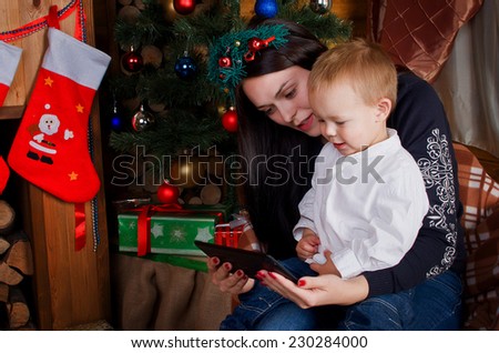 Mom and son holding a tablet PC. Watching cartoons in a festive atmosphere