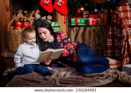 Mom and son reading a book in a Christmas setting