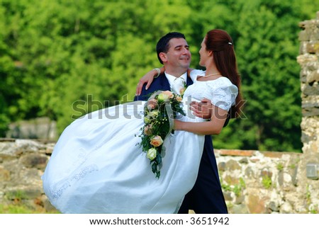 marriage  pair in front of a stones  wall