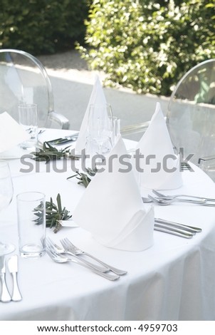 a ceremonial decorated dinner table in white