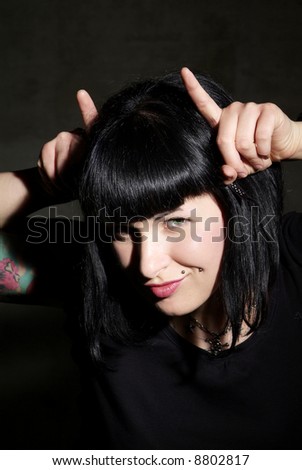 a woman with black hair and piercing 