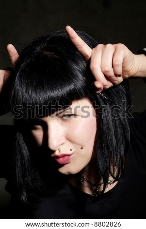 a woman with black hair and piercing 