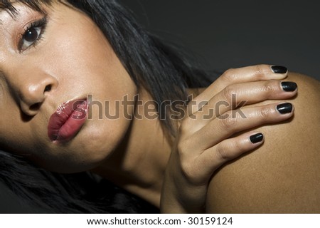 portrait of a young pretty asian woman with hand on shoulder