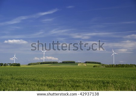 big windmill green field meadow blue sky