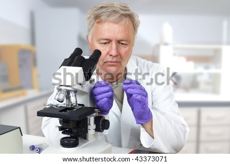 Researcher in the lab looking on microscope slide