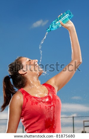 Young woman splashing herself with water
