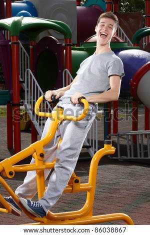 Young man having fun on a fitness machine