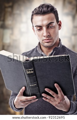 Portrait of a young man reading the Holy Bible Portrait of a young man reading the Holy Bible