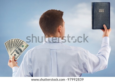 Young man choosing between God and money