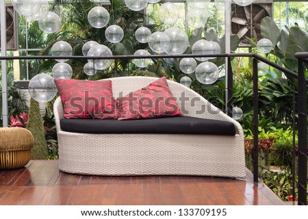 Weave Sofa With Red Pillows In The Garden