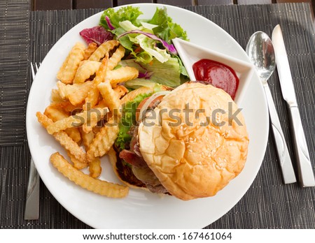meat hamburger with french fries and salad on white dish