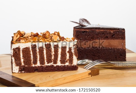crispy almond chocolate cake and chocolate cake on wood board